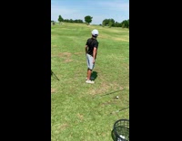 Boy throws golf club onto green shed