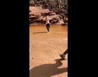 Blonde girl pink shirt dance muddy water