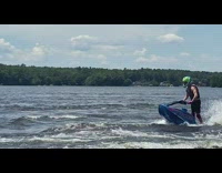 Green helmet guy spins blue jet ski