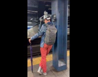 Man at subway wearing rotating disco hat