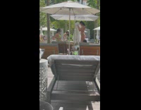 Woman green bikini pose on bed beach