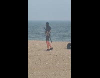Man practice his dual katana at beach
