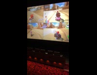 Friends playing Super Mario Cart inside cinema