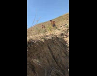 Guys jumps off cliff in water