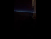 Plane view thunder clouds with blue light above