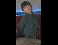 Woman bangs turtleneck sleeves look upward restaurant