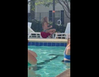 Girl sits near pool with ring light 