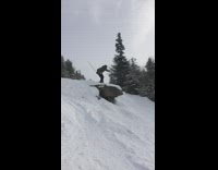 Skier does a jump off cliff and falls on back