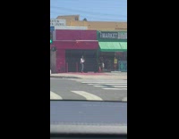 Black shirt guy dances sidewalk green awning 