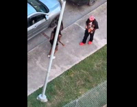 Two women tiktok dance beside parked car
