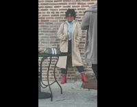 Girl brick wall long khaki coat 