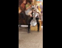 two people in silver masks playing instruments in subway station