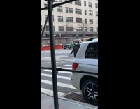 Guy wearing white mask rides green motorcycle 