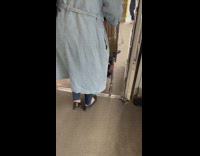 Boy lays at bottom of moving shopping cart 