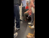 Shirtless man sing and dance on train