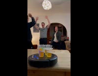 Guys play beer pong cups on roomba
