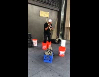 Collab WINY - Man wear orange buckets play trombone street