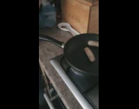 Sausage rolls around black frying pan stove 