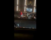 Car driver with leg and arm out window