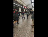 Man in sparkly glitter jacket dances to Thriller Michael Jackson in subway station