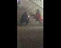 Woman orange dress sit stairs photo shoot night