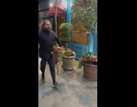 Guy watches man carry grocery bags 