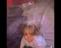 Baby in bed with smoke coming out of head 