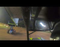 Guy drives micro sprint car around racetrack 