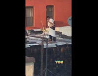 Guy white shirt with holes paints roof