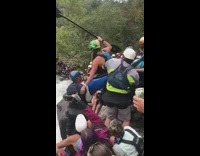 Crowd lifts throws girl blue kayak river