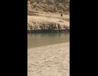 Kid floater in water woman lay beach