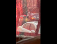 Gray zipcar car flipped upside down street