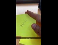 Guy throws sticky note sticks on window