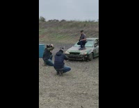 Guy picture hood of camo car