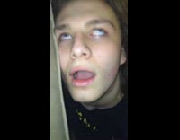 guy black shirt sitting down with eyes rolled back