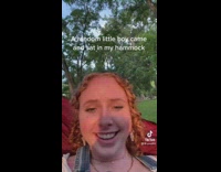 Random little boy sits on hammock asks about freckles