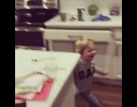Boy says happy birthday to dad in kitchen, runs into little sister who falls and trips other sibling
