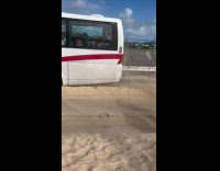 People stranded inside bus with strong wind