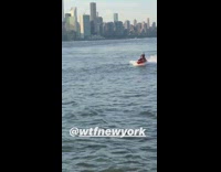 Joker cosplay outfit rides red jet ski in New York waters