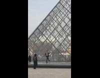 Black suit guy pretends walk louvre pyramid 