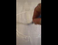 Artist paints mountains and lake on canvas 