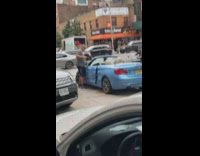 Guy uses hammer to break car windshield 