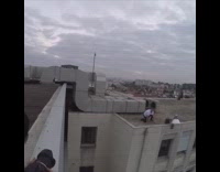 guy white shirt black pants jumps from buildings 