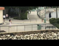 Woman white dress black railings walk rocks