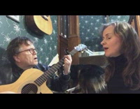 Husband and wife sing song together for dog