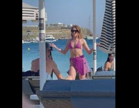 Woman in violet bikini talks and dances