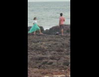 Woman white top blue green skirt dress beach