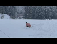 Man in shorts dive in snow trees