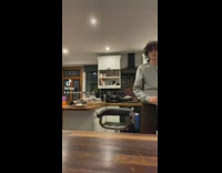 Guy uses cat as towel to dry table 