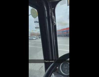 Red train moving in middle of street